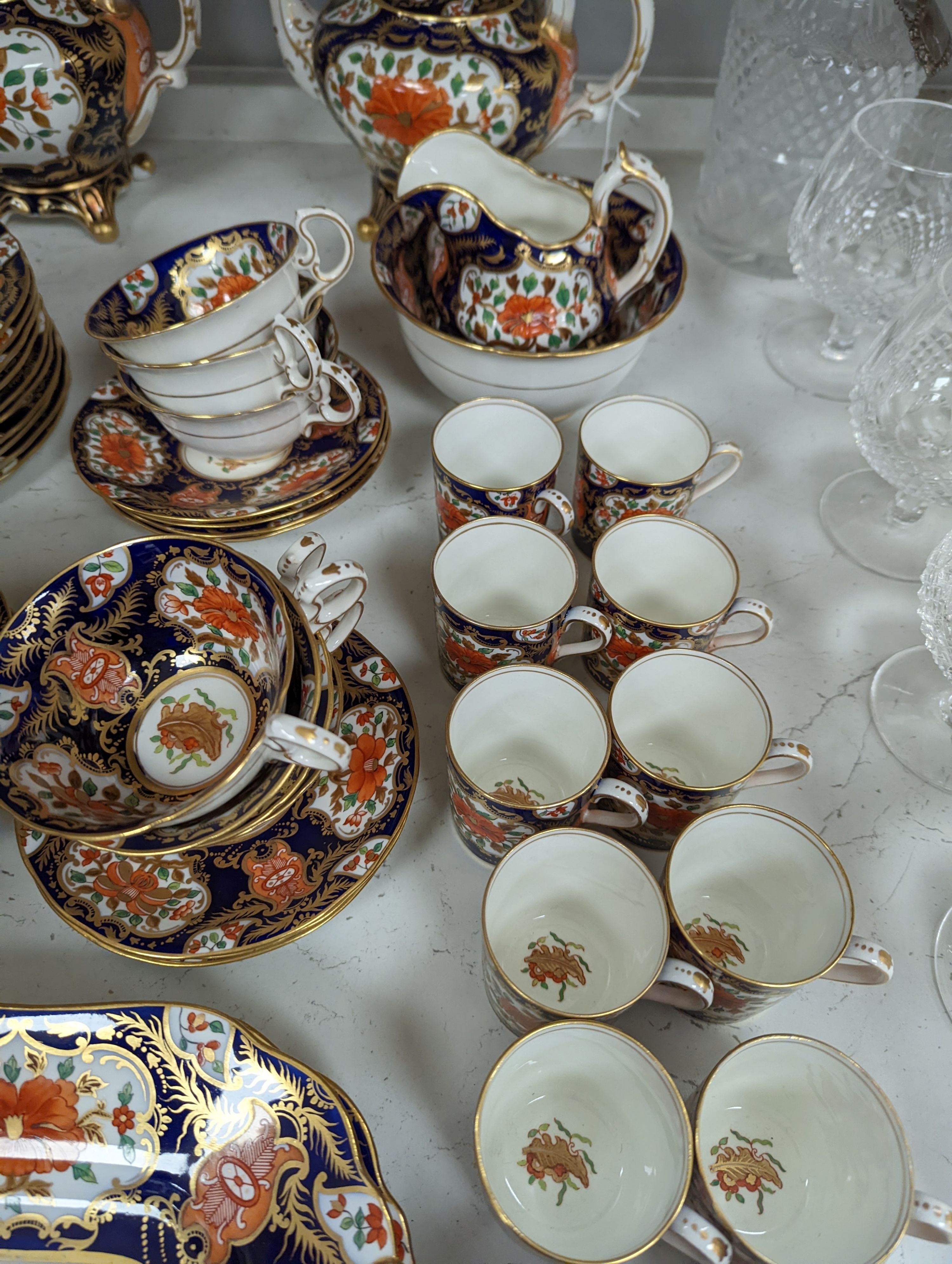 A mid 19th century English bone china fifty-two piece part tea and coffee service, decorated in an Imari pattern
